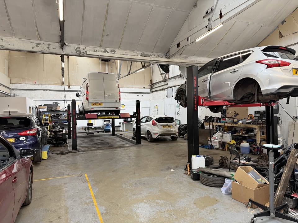 Drive On Garage workshop with several vehicles being serviced